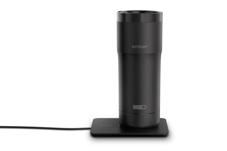 Ember temperature control mug on its charging base.
