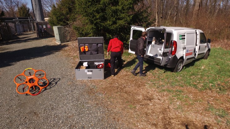 Measure employees set up drones for an aerial inspection.